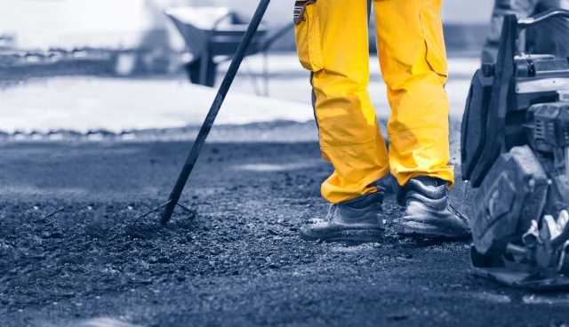 person laying asphalt