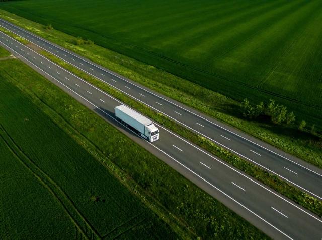 truck on road and open fields