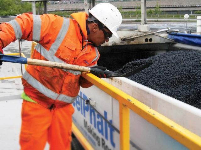 SteelPhalt team member shoveling SteelStop