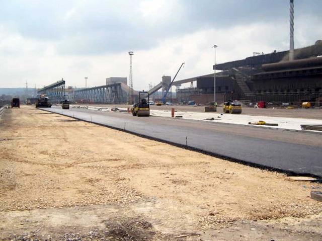 paving a road with building in background