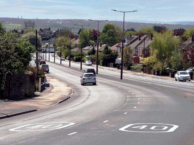 cars driving on hilly road